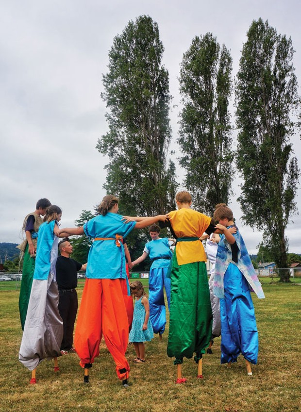 A group of young stilt walkers from the Arcata Playhouse Pageant on the Plaza workshop forms a circle before performing a play, The Battle of the Elements, at Annie and Mary Days on Sunday, July 13, at Perigot Park in Blue Lake. (The pageant was also presented on Saturday on the Arcata Plaza.) - PHOTO BY BOB DORAN