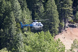 PHOTO BY PRESTON DRAKE-HILLYARD - A helicopter searches for Sophia Pedreros-Parker Saturday, May 21