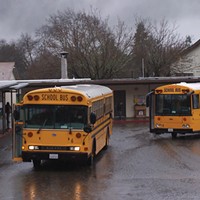 A SCHOOL BUS DROPS OFF STUDENTS AT REDWAY ELEMENTARY SCHOOL.