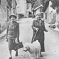 Alice B. Toklas and Gertrude Stein walk their dog in a village in southeastern France. Photo from the collection of University of California, Berkeley's Bancroft Library.