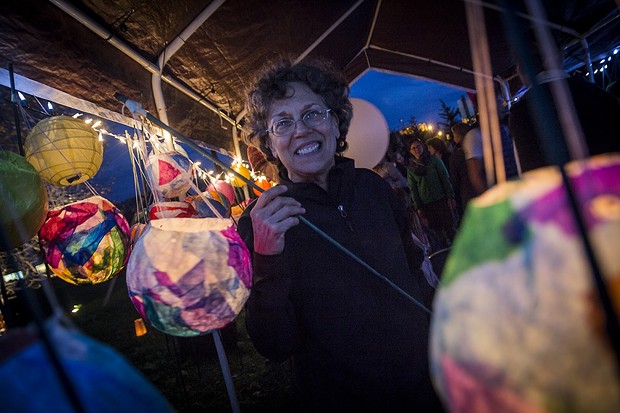 Barbara Reisman picks up a lantern at the Blue Lake Harvest Days community pageant. - MANUEL J. ORBEGOZO
