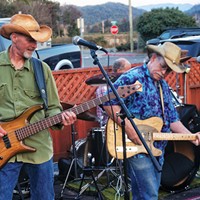 Bassist Ron Sharp and lead guitarist Rick Levin of the cosmic American music band Cadillac Ranch trade licks at a dance concert at Mad River Brewery in Blue Lake on a warm summer Friday evening, Aug. 15.