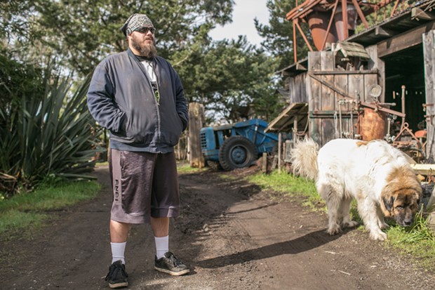 Cody Drury, an Army veteran, with Bluto. Drury served from 2002 to 2004 in the mortar infantry. He helped build the Lincoln hearse and became skilled at Blue Ox in numerous trades. He says Blue Ox is his sanctuary. - PHOTO BY ALEXANDER WOODARD
