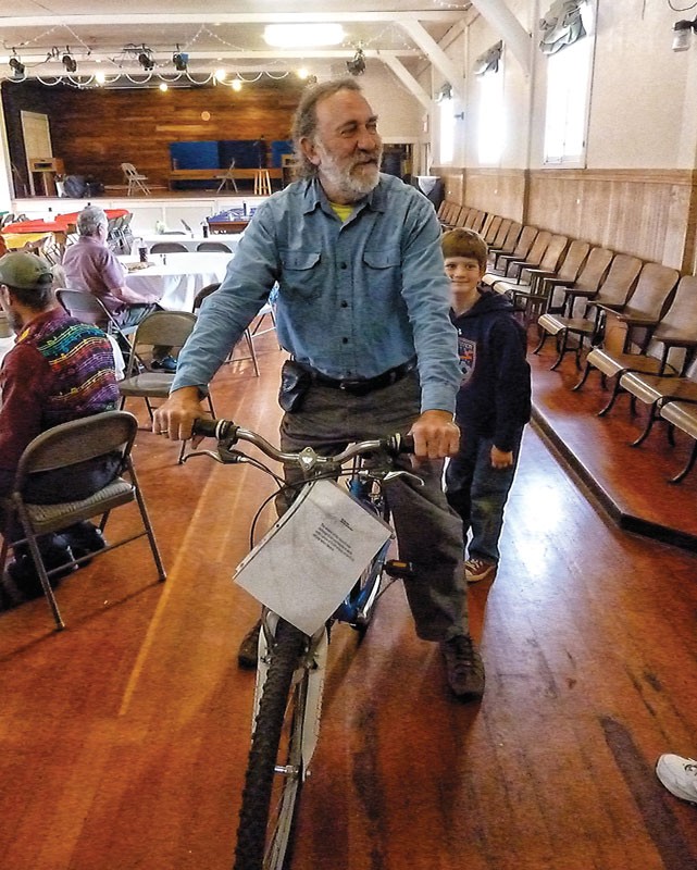 David Katz former owner of SoHum's Alternate Energy Engineering, was the lucky winner of a raffle for a bicycle at the Bayside Grange Gourmet Breakfast and Electric Vehicle Show on April 27. Katz and his wife, Anne Braak-Katz, drove their electric car to the annual Earth Day brunch; she decided the bike was hers and rode it home. - PHOTOS BY BOB DORAN