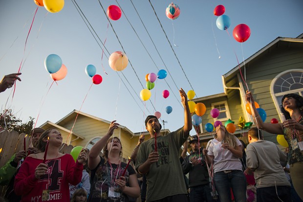 Friends and family release balloons during a vigil for Thomas "Tommy" McClain held at the scene of Wednesday's shooting. - MARK MCKENNA