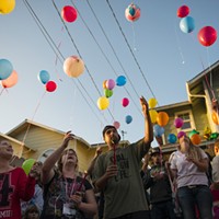 Friends and family release balloons during a vigil for Thomas "Tommy" McClain held at the scene of Wednesday's shooting.