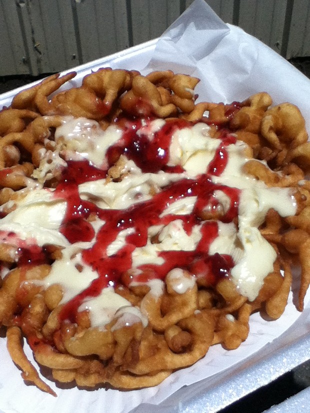 Funnel cake topped with sweet cream and raspberry sauce. - JENNIFER FUMIKO CAHILL
