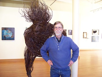 Jack Sewell with his plum twig sculpture "Transplantation." - JENNIFER FUMIKO CAHILL