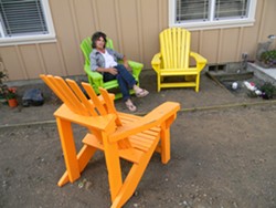 PHOTO BY CARRIE PEYTON DAHLBERG - Kathy Sherwood, sitting in one of the chairs she painted, acknowledges that where to put affordable housing is a "huge" question.