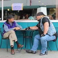 Stan Elsworth, described as his producer as a "big, burly biker dude" with an interest in history, talks with local historian Ray Hillman in Eureka.