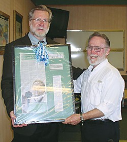 Mad River Hospital CEO Doug Shaw (left) awards a plaque to Carl Willoughby. Photo by Vicky Sleight.