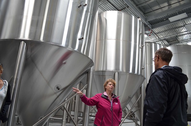 Groom shows off the brewery's fermentation tanks. - GRANT SCOTT-GOFORTH
