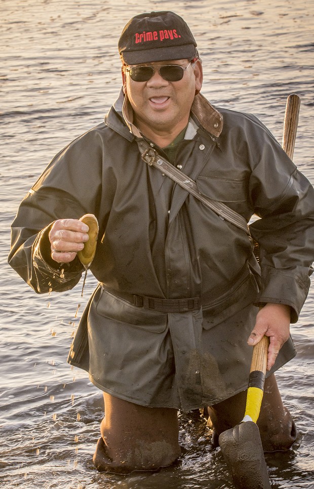 James Louis, of Eureka, said he's known as the "black belt clammer" after 45 years of successfully pursuing razor clams on Clam Beach. He held up one example of the tasty clam after going to his knees to dig it out on a low tide just before sunset on Tuesday, Jan. 20. - MARK LARSON