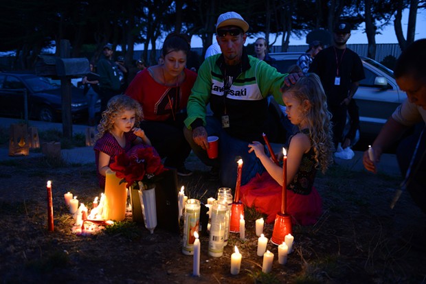 Nichole and Josh Mottern sit near a photo of McClain with their daughters Kendra, right, and Valorie. Josh Mottern was McClain's cousin and McClain had been living with the Motterns at a home on Allard Avenue in Eureka. McClain was fatally shot outside the home early Wednesday morning. - MARK MCKENNA