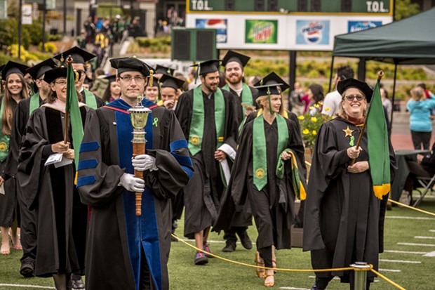 Professor Noah Zerbe, Department of Politics, served as the mace bearer and professors Cindy Moyer, Music, and Sarah Wharf, Art, followed in their role as marshalls as they led the graduate and undergraduate students into Redwood Bowl. - MARK LARSON