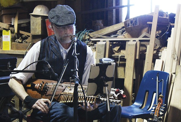 Sam McNeill of Good Company, mixing the ancient and the modern &mdash; playing a solo set of traditional Swedish music on a nyckelharpa and reading the tunes from his iPad &mdash; at the May 3 Blue Ox May Day Living History and Artisan Fair. - PHOTOS BY BOB DORAN