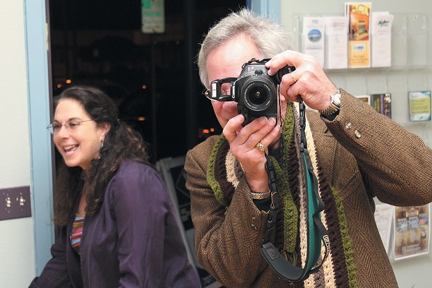 Shutterbug Rick St. Charles turns the tables on the paparazzi at an Arts Alive! opening at MikkiMoves. That's Michelle "Mikki" Cardoza photobombing the shot.