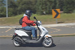 Tim Patton negotiates a curve on the round about just east of Highway 101 on Old Arcata Road. Patton recently purchased a Piaggio Fly 150 made by Vespa to  commute from his home in Eureka to his cabinetry business on West End Road. Photo by Mark McKenna