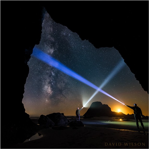 At one point while photographing, my brother and I played with our light beams beneath the cosmos, careful not to cross the streams. We tried one take on this, and by luck our beams formed a little house over the setting moon and Camel Rock. - DAVID WILSON