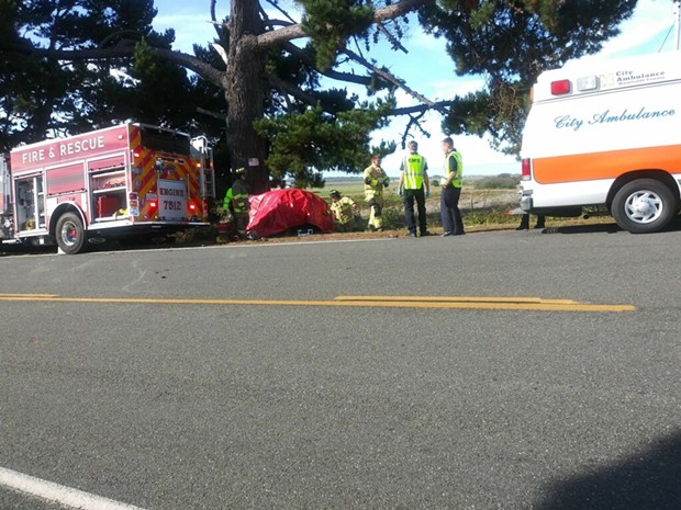 Emergency crews at the scene of the Loleta crash. The car is wrapped in a red tarp. - BOBBY KROEKER