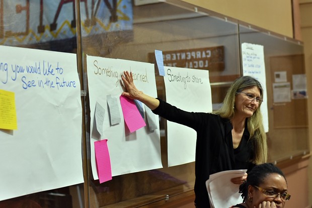 Editor of the Humboldt Historian Suzanne Forsyth places her feedback about what she learned on a poster board at the Womxn’s Conference March 9 in the Labor Temple - PHOTO BY MEGAN BENDER