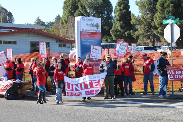 St. Joseph and Redwood Memorial Hospital healthcare workers striking in front of the St. Joseph Lane entrance to St. Joseph Hospital in Eureka. - IRIDIAN CASAREZ