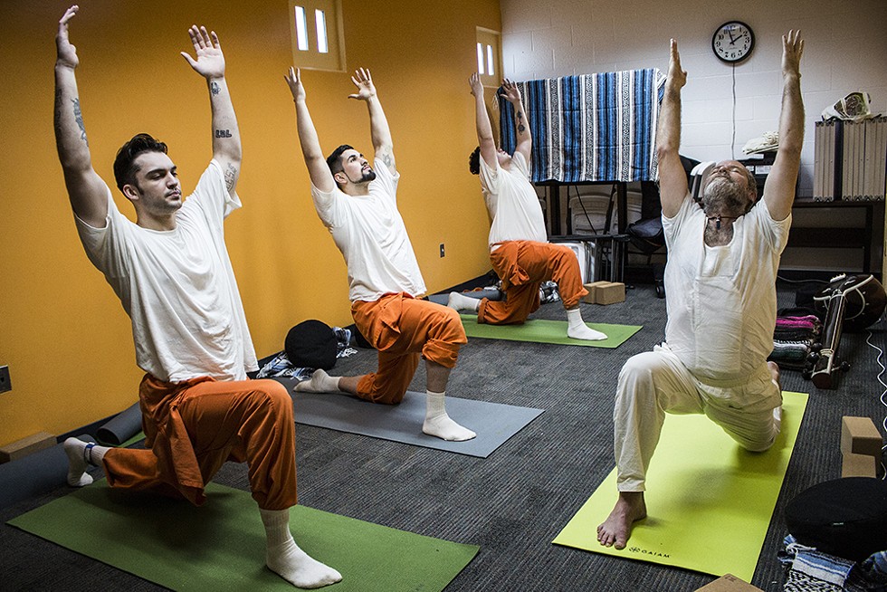 Rob Diggins (right) teaches a yoga class, a favorite of some inmates, inside the Humboldt County jail. - PHOTO BY T. WILLIAM WALLIN