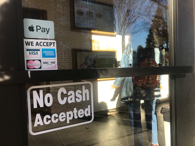 A "No Cash Accepted" sign at a restaurant. - JACKIE BOTTS/CALMATTERS