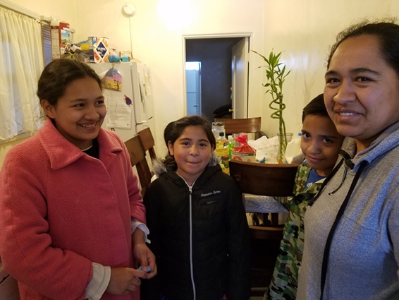 Los Angeles mother Adriana Fuentes, right, says she’s not sure she can afford internet for her children Kimberly Fuentes, 13, Alejandra Delgado, 8, and Christopher Delgado, 10. - PHOTO BY ELIZABETH AGUILERA FOR CALMATTERS