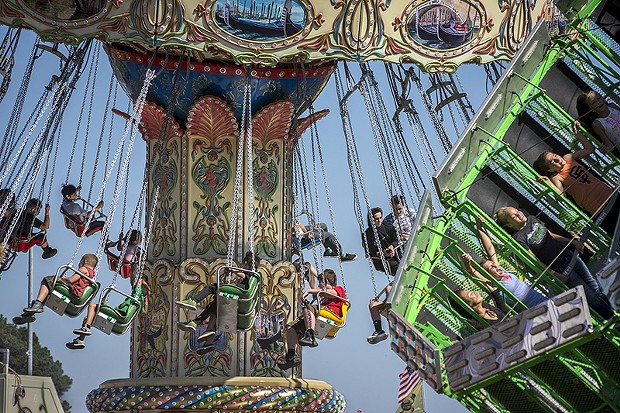 The midway rides were a popular way to catch a cool breeze. - PHOTO BY MARK LARSON