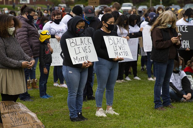Demonstrators bow thier heads as they observe a moment of prayer to open a protest of police brutality and racism at Rohner Park in Fortuna on June 5. - THOMAS LAL