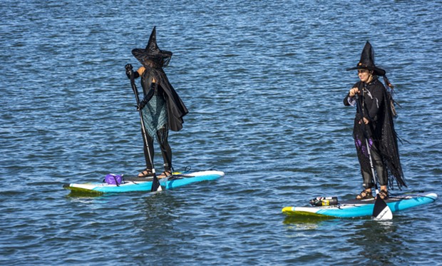 These well-dressed witches on stand-up paddle boards headed back to the put-in location after turning around at the Samoa Bridge Boat Launch near Halvorsen Park. - PHOTO BY MARK LARSON
