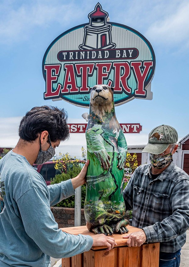 Amanita Mollier's otter is prepped for installation at the Trinidad Bay Eatery and Gallery by Ben Sparks and professor Jeff Black. - MARK LARSON