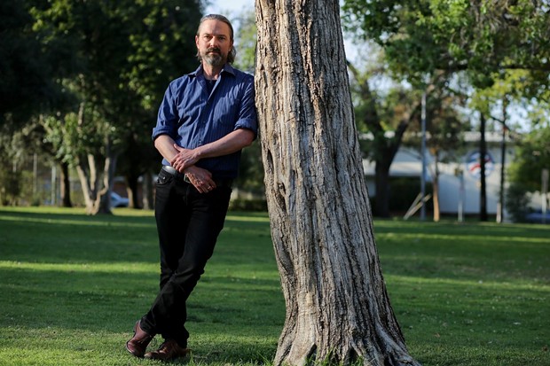 David Walter stands for a portrait at Encino Park in Encino on March 23, 2021. David is an adjunct professor at UC Berkeley lecturing on humanities and creative writing. - PHOTO BY SHAE HAMMOND FOR CALMATTERS