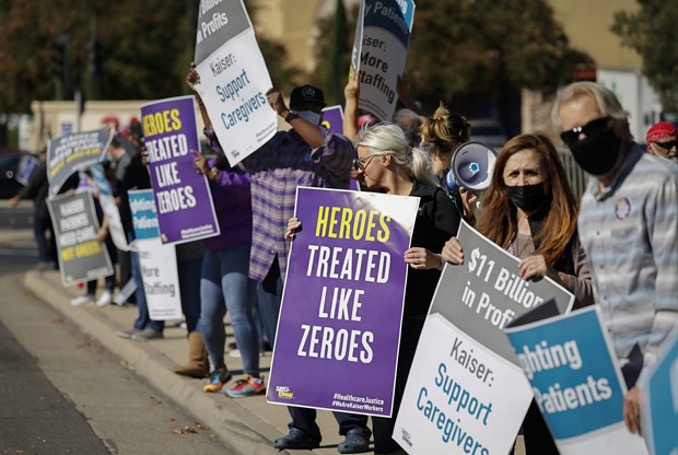 Hospital staffers and union organizers waved signs and banners in protest over staffing shortages at Kaiser Permanente Hospital in Roseville on Oct. 14, 2021. - PHOTO BY FRED GREAVES FOR CALMATTERS
