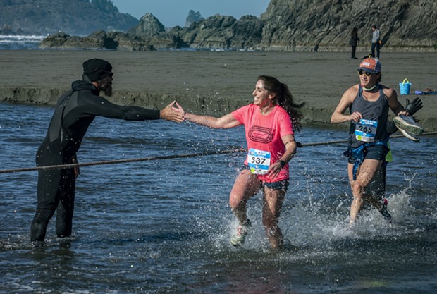 Laura Holt (No. 537), of McKinleyville, splashed her way across Little River and finished in 12th place among the women. - PHOTO BY MARK LARSON
