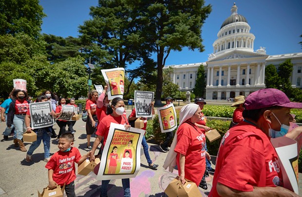 Fast-food workers and other SEIU members marched to the Capitol to deliver postcards and petitions in support of AB257 to the Governor's Office on May 31, 2022. - PHOTO BY FRED GREAVES FOR CALMATTERS
