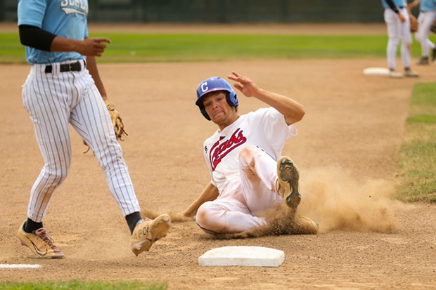 Crabs first baseman Tyler Davis slides safely into third base on July 31. - THOMAS LAL