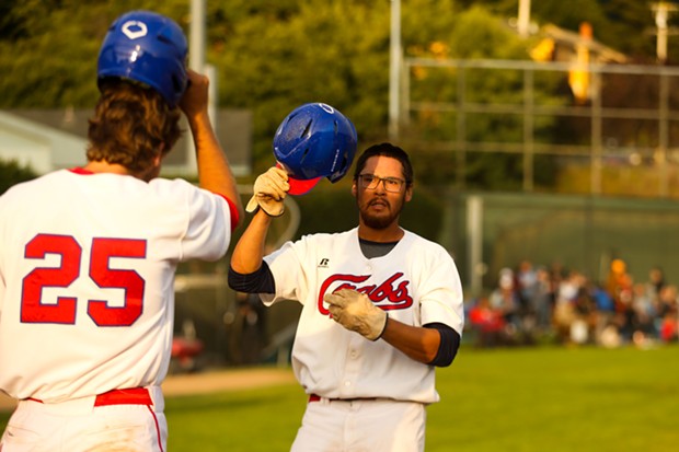 Crabs third baseman Javier Felix celebrates at home plate with teammate Tyler David after hitting a home run against TKB Baseball on July 26. - THOMAS LAL