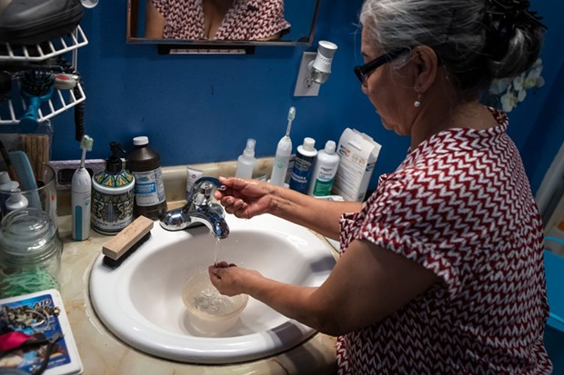 Maria Diaz keeps a bowl in the sink to save water while she washes her hands on Aug. 8, 2022. - PHOTO BY LARRY VALENZUELA, CALMATTERS/CATCHLIGHT LOCAL