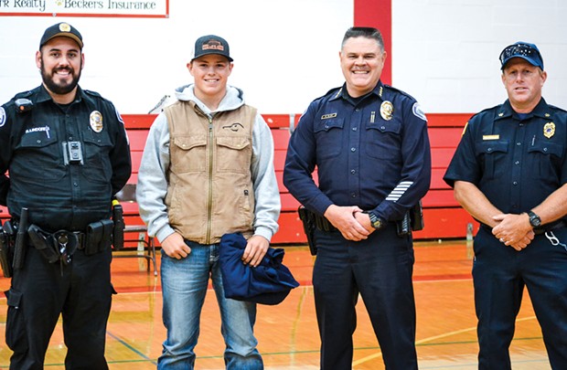 Ferndale Police Sgt. Robert Lindgren, Levi Dixon, Ferndale Police Chief Ron Sligh and Assistant Ferndale Volunteer Fire Chief Rick Nicholson at an assembly honoring Dixon. - SUBMITTED