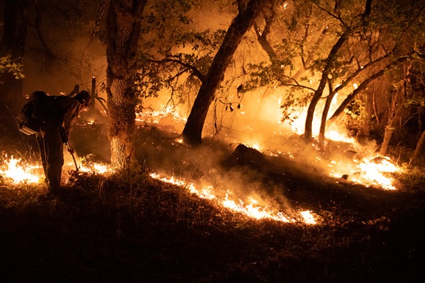 Firefighters defended houses at the end of Enchanted Creek Lane in September of 2021. - PHOTO BY MARK MCKENNA