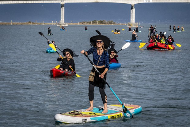 On Saturday, Oct. 21, Christine Fiorentino and fellow Witches Paddle participants left the Samoa Bridge boat ramp and headed west on Humboldt Bay into a stiff wind. - PHOTO BY MARK LARSON