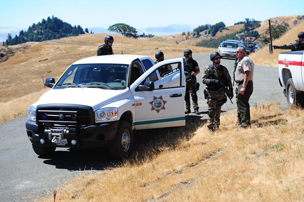 Humboldt County Sheriff's Office personnel stage about a mile away from Wilde's Ashfield Ranch property on Aug. 26, 2010. - FILE