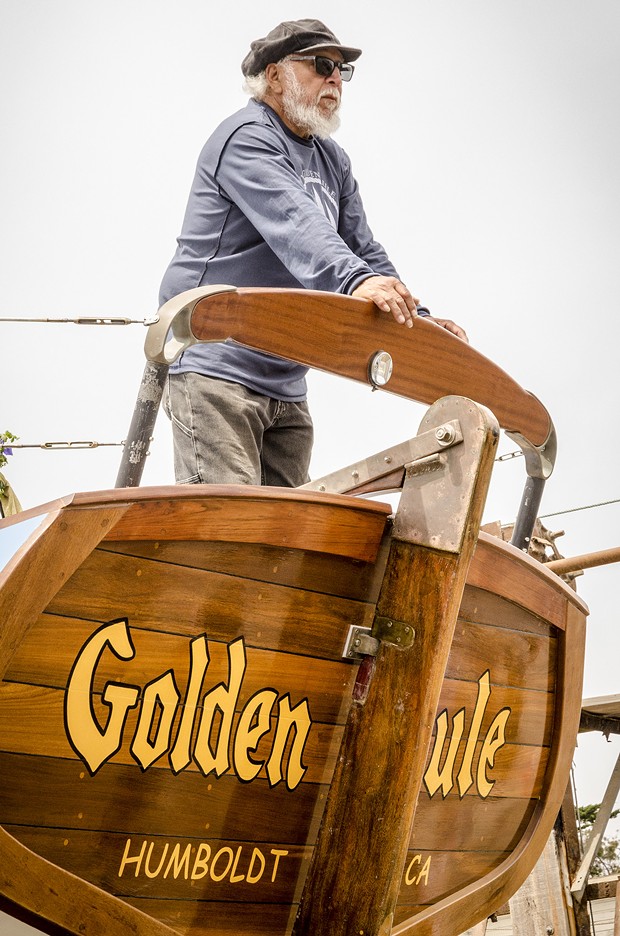 Michael Gonzalez, of Trinidad, pauses for a moment on the rear deck of the Golden Rule prior to its launching on Saturday, June 20 at the Zerlang & Zerlang  boat yard on the Samoa peninsula. He said he was easily persuaded to join the restoration project over three years ago when he heard it was a wooden boat. - MARK LARSON