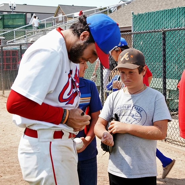 Jeff Ruby signs autographs after the Crabs' win Sunday. - SUBMITTED