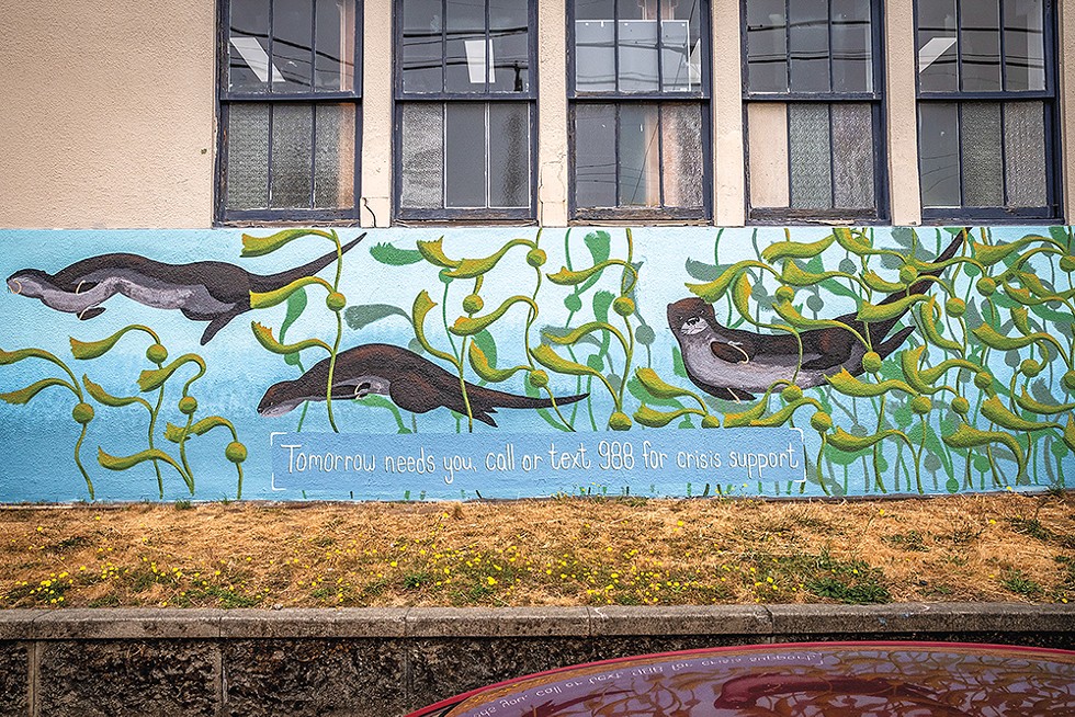 Mural artist Melitta Jackson's "Chpaana'r" ("stay a long time" in Yurok) mural on the drab exterior on the E Street side of the Eureka Municipal Auditorium included this message from her sponsor, the Suicide Prevention Network. Her art is inspired by her Indigenous culture and the natural environment. - PHOTO BY MARK LARSON