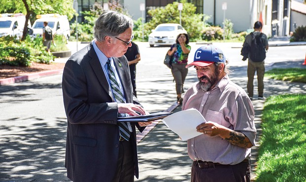 Communications lecturer Aaron Donaldson (right) explains a map detailing Cal Poly Humboldt's many accessibility issues to Acting President Michael Spagna on Aug. 28. Spagna, speaking on one of his first days on campus, said he wanted more information on why the documented issues have not been addressed. - PHOTO BY THADEUS GREENSON