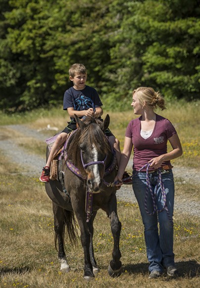 Landon Porter, 7, Crescent City, enjoyed the horseback rides offered by Hailey Ford, McKinleyville and the Redwood Creek Buckarettes. The group offers guided tours in Redwood National Park. - MARK LARSON