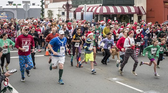 The crowd of racers putting the "sweat" in "sweater" during Sunday's Ugly Sweater Run. - MARK LARSON